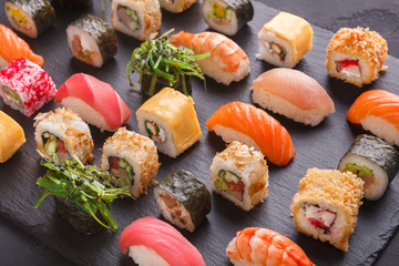Set of sushi maki and rolls on gray background