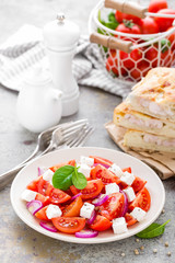 Tomato salad with fresh red onion and feta cheese. Healthy eating