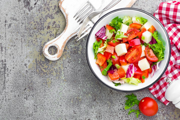 Vegetable dish, salad with bell pepper, tomato, italian mix, fresh lettuce and mozzarella cheese. Healthy food. Top view