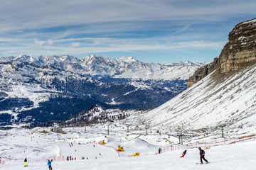 View on a sunlit ski slope and a Gondola ski lift in the Ski Resort Madonna di Campiglio, South Tyrol, Trentino, Italy