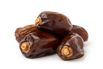 Pile of dried dates on a white