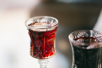 Two glasses of homemade red wine close up with copy space