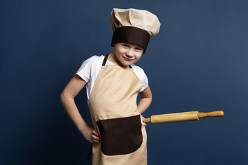 Food chef concept stay with kitchen instrument and look into the camera