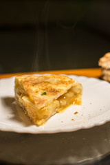 Piece of spanish omelette in a white plat