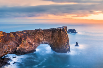 Dyrholaey rock formation at sunset. Dyrholaey is a promontory located on the south coast of Iceland, not far from the village Vik © mandritoiu