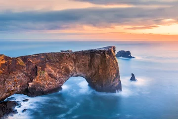 Fotobehang Dyrholaey rock formation at sunset. Dyrholaey is a promontory located on the south coast of Iceland, not far from the village Vik © mandritoiu