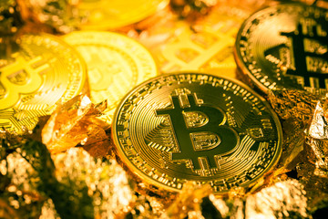 Shiny bitcoin coin macro with gold flakes