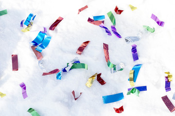 colored ribbons scattered in the snow