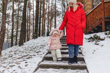 mother with baby walking picturesque country cottage in