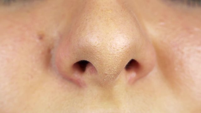 A woman breathes through her nose - closeup