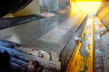 Magnetic plate on the grinding machine. Electric magnetic sine table.