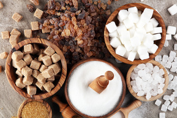 Various types of sugar, brown sugar and white on table