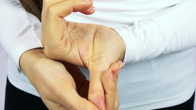 A woman stretches her fingers and hands - closeup