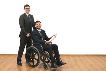 The man and the invalid hold papers on the white wall background