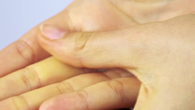 A woman rubs her hands - closeup