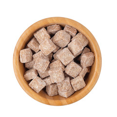 Brown sugar in a wooden bowl on a white background isolated. Top view.