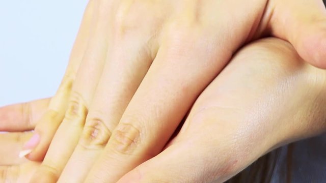 A woman rubs her hands - closeup
