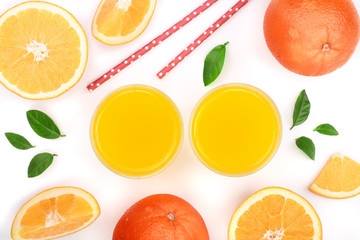 orange juice glass with slices of citrus and green leaves isolated on white background, top view. Flat lay pattern