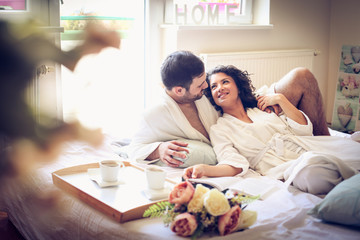 portrait of young couple in bed  at morning.