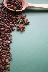 Raw coffee beans on a wooden spoon