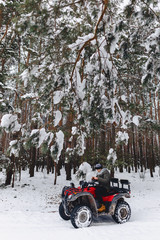 The guy rides a motorcycle in a snowy weather