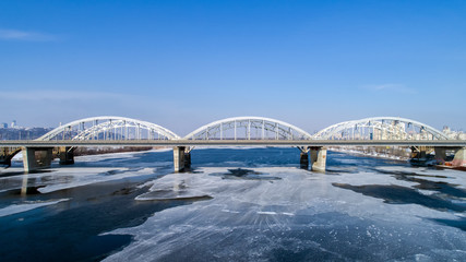 Aerial view of the Kiev city, Ukraine. Dnieper river with bridges. Darnitskiy bridge