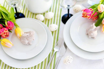 Beautiful table setting with crockery and flowers for Easter celebration