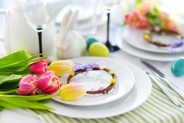 Beautiful table setting with crockery and flowers for Easter celebration