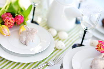 Beautiful table setting with crockery and flowers for Easter celebration