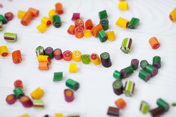 Colorful lollipops, candy canes and sweet candies mix on wooden background