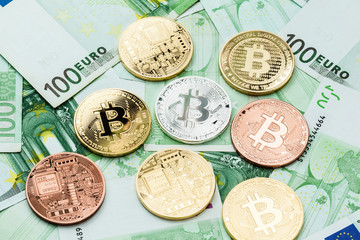 Different bitcoin coins on Euro bills