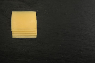 Sliced Cheese Over Stone Background