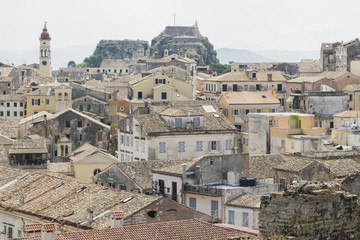 Obraz premium View on Old Fortress of Corfu city or Kerkyra from New Fortress. Skyline of typical houses of old town. Tourist attraction and popular vacation destination. Sunny day in beginning of June. 