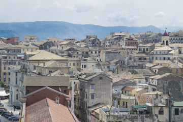 Fototapeta na wymiar View on Corfu city or Kerkyra from New Fortress. Skyline of typical houses of old town. Tourist attraction and popular vacation destination. Sunny day in beginning of June. 