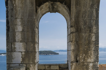Fototapeta na wymiar View across harbor from wall sightseeing point of New Corfu Fortress in June. Corfu town or Kerkyra , Corfu Island, Greece. 