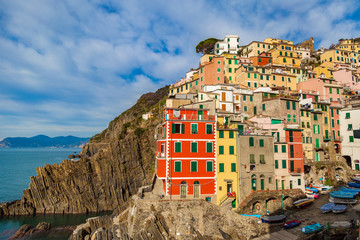Fototapeta na wymiar Scenic view of Riomaggiore with its colorful buildings and coastline. Cinque Terre, Liguria, Italy
