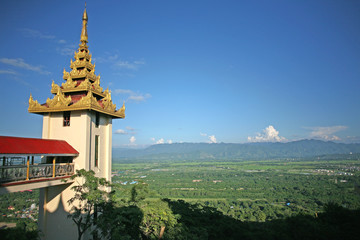 The palace pagoda complex at the summit of the hill of the Su Taung Pyae Pagoda above Mandalay in Myanmar