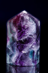 Macro mineral stone Fluorite crystal on a black background