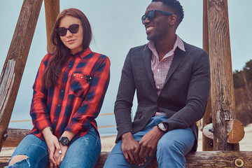 Attractive couple on the beach. African-American guy and Caucasi