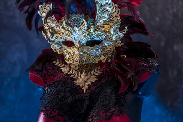 Decoration Venetian red, mask and red corset with pieces of gold and black lace fabrics on metal breastplate. handmade piea for parties or costume meetings