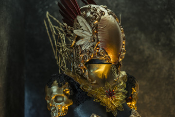 Shield, fantastic gold armor and handmade metal pieces, it has a gold dragon scaled breastplate with a helmet of gothic pieces and red feathers, it has a red skirt and metal pieces of jewelery