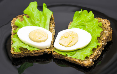 sandwiches on a black plate