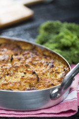 Close up of a golden colored gratin served on a table.