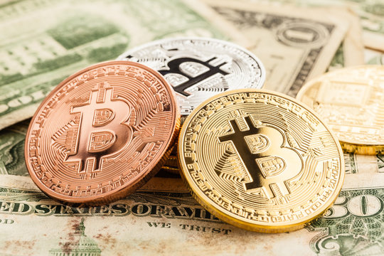 Different Bitcoins on Dollar bills