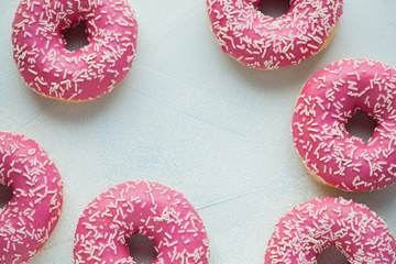 Donut. Sweet icing sugar food. Dessert colorful snack. Glazed sprinkles. Treat from delicious pastry breakfast. Bakery cake. Doughnut with frosting. Baked unhealthy round. Top view with copy space
