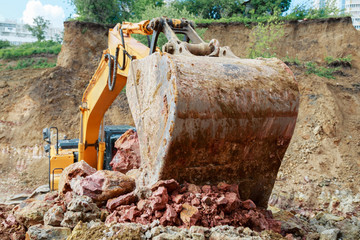 Fototapeta na wymiar Excavator bucket close-up. Work at the construction site.