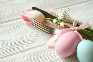 Easter laying table appointments, table setting options. Silverware, tableware items with festive decoration. Fork, knife and flowers. Happy easter holiday.