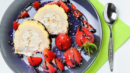 Sliced ice cream and fresh strawberries on plate.