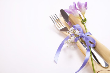 Easter laying table appointments, table setting options. Silverware, tableware items with festive decoration. Fork, knife and flowers. Happy easter holiday.