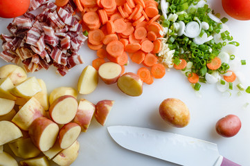Spring vegetables and bacon on the kitchen table.Healthy foods are on the table. Homemade food preparation.